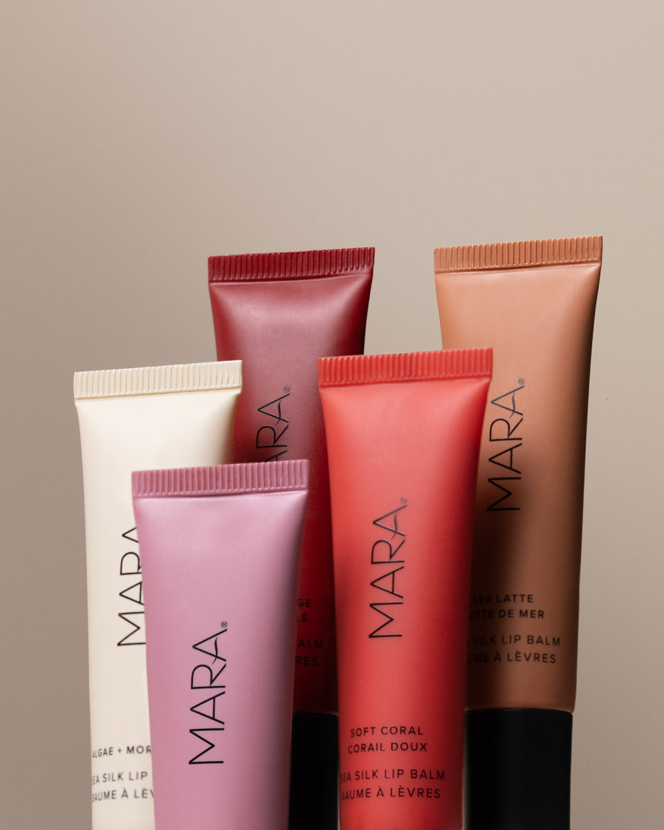 five shades of Sea Silk Lip Balm on light brown background