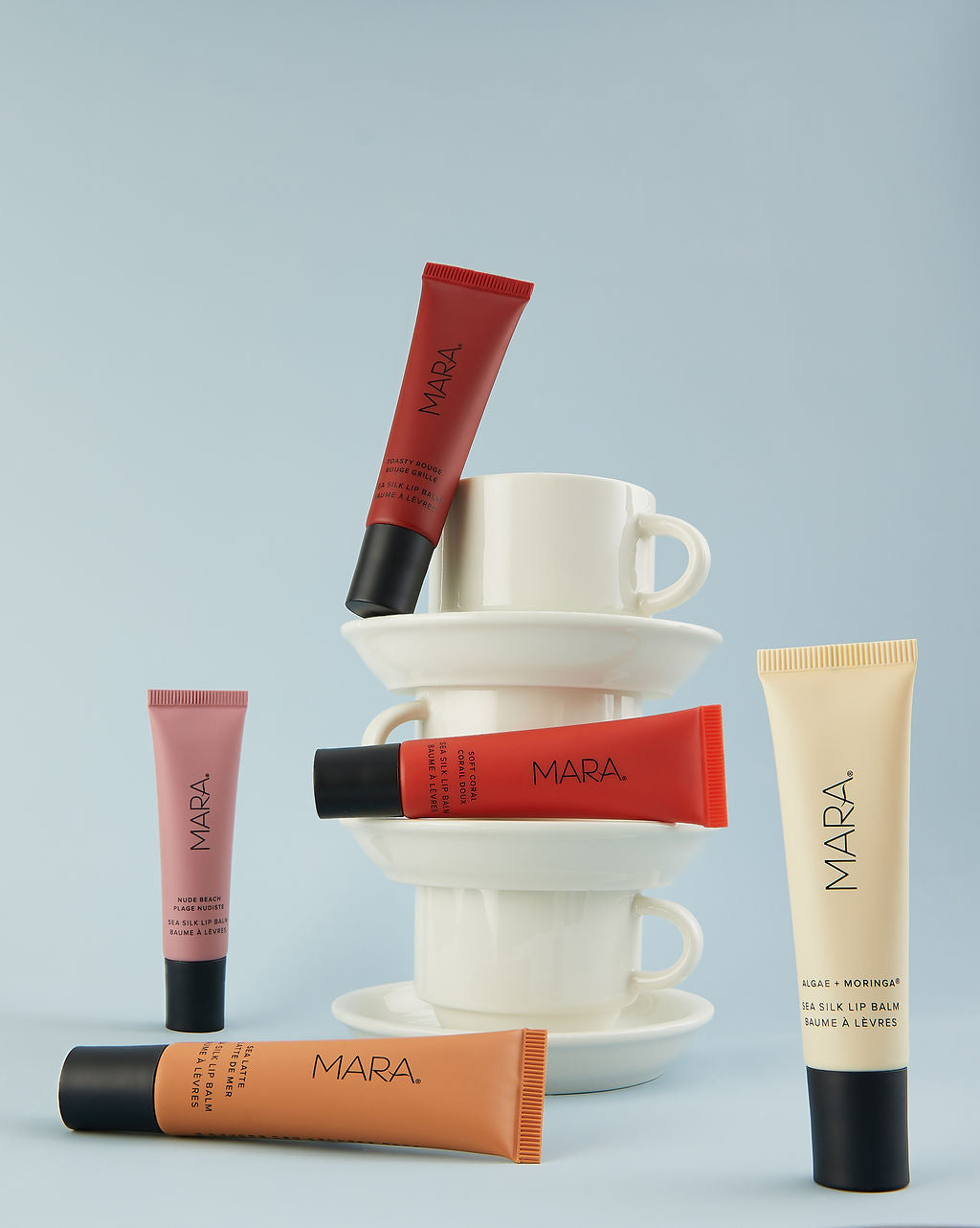 MARA Sea Silk lip balm tubes in various colors on a light blue background