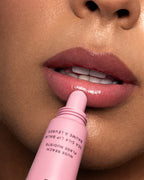 Close-up of a person applying Nude Beach Sea Silk Lip Balm