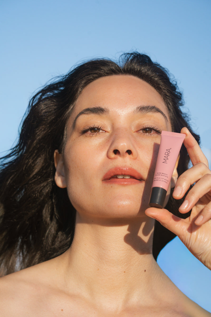 woman holding Nude Beach Sea Silk Lip Balm