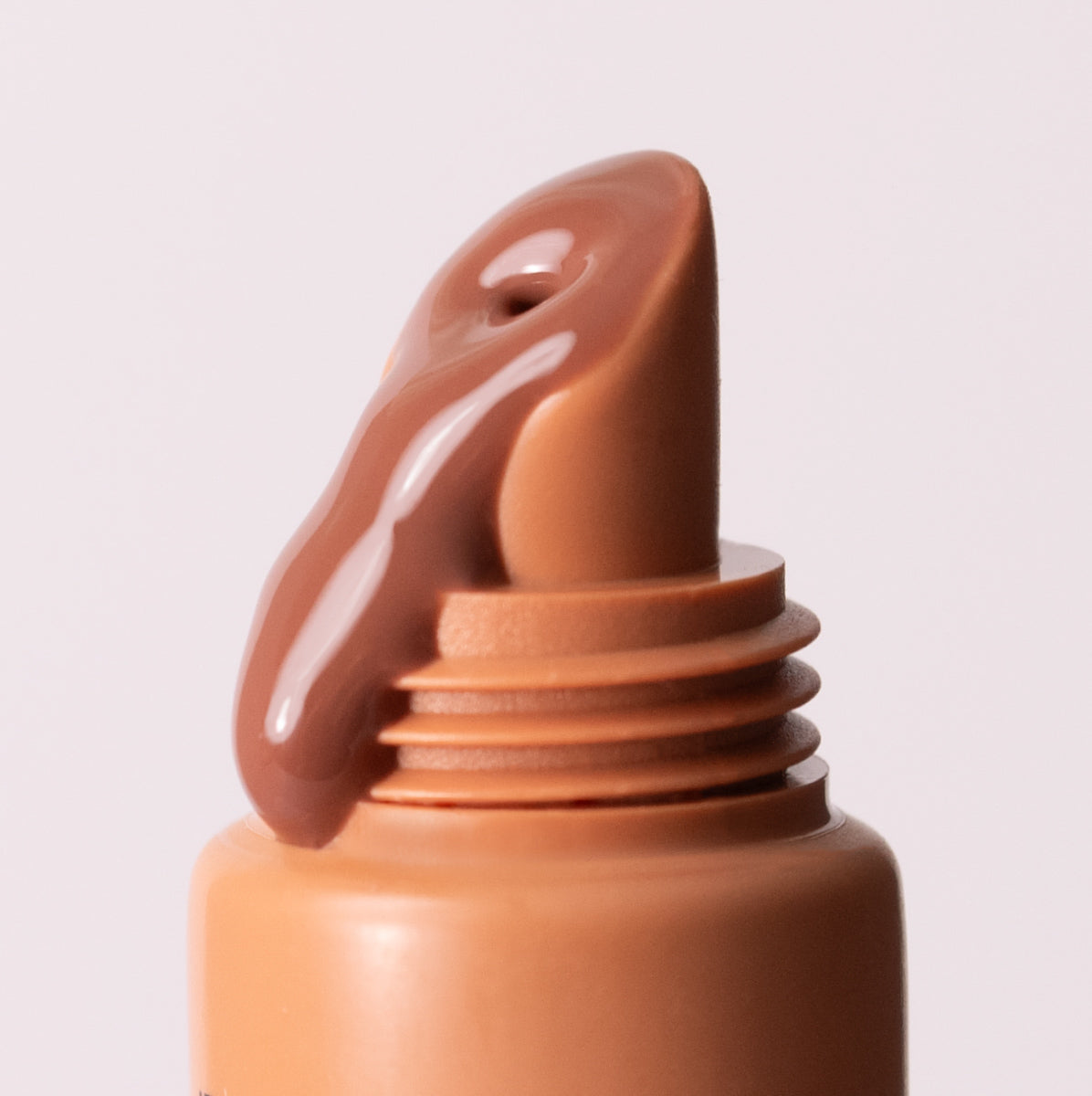 Close up of Sea Latte Sea Silk Lip Balm spilling out of applicator