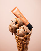 Chocolate Ice cream cone with two scoops and Sea Latte Sea Silk Lip Balm on a beige background