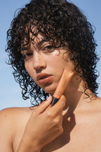 Model wearing Sea Silk Lip Balm in Sea Latte