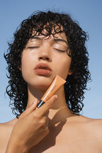 Person holding Sea Silk Lip Balm Sea Latte 