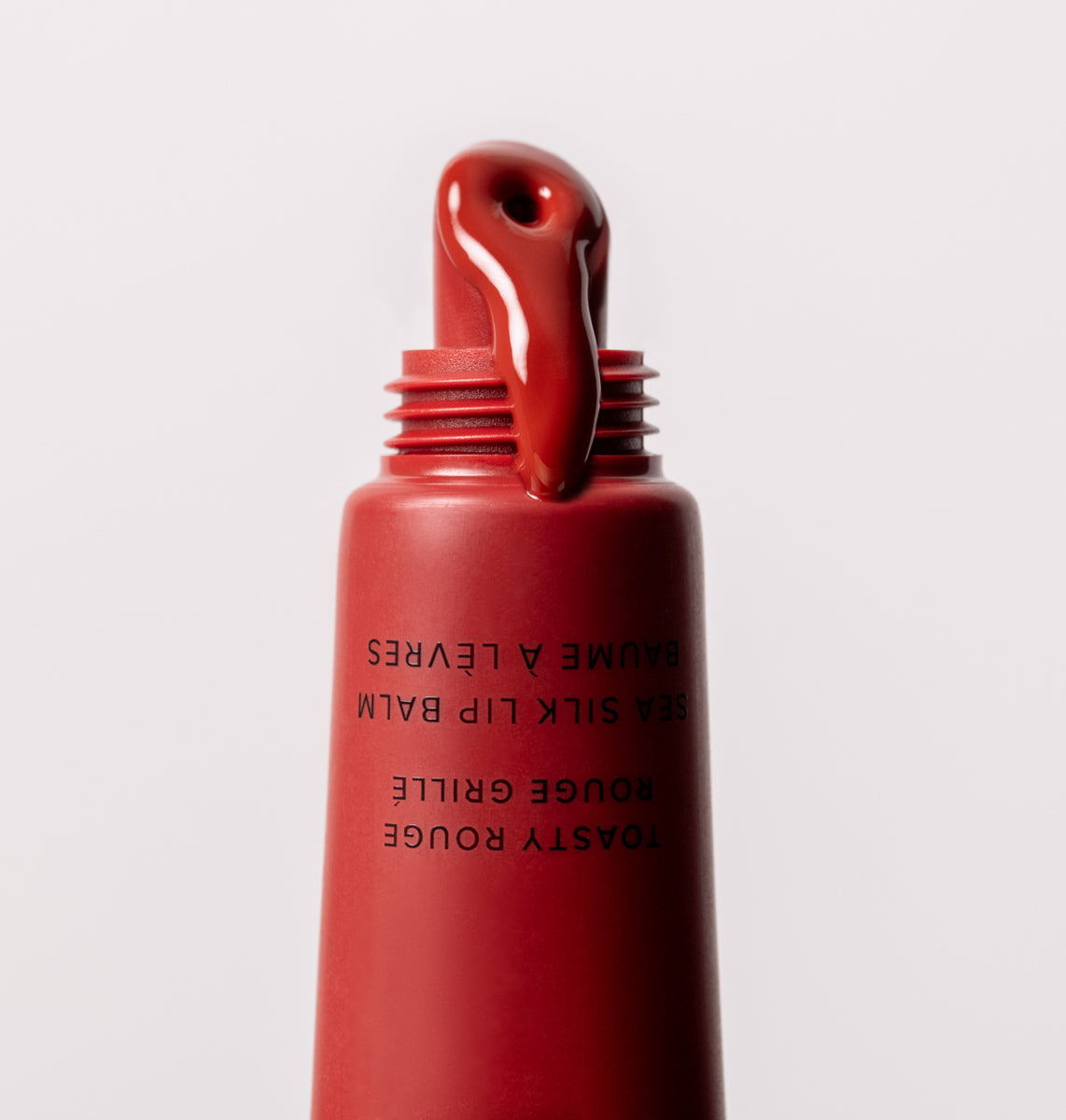 Toasty Rouge Sea Silk Lip Balm spilling out