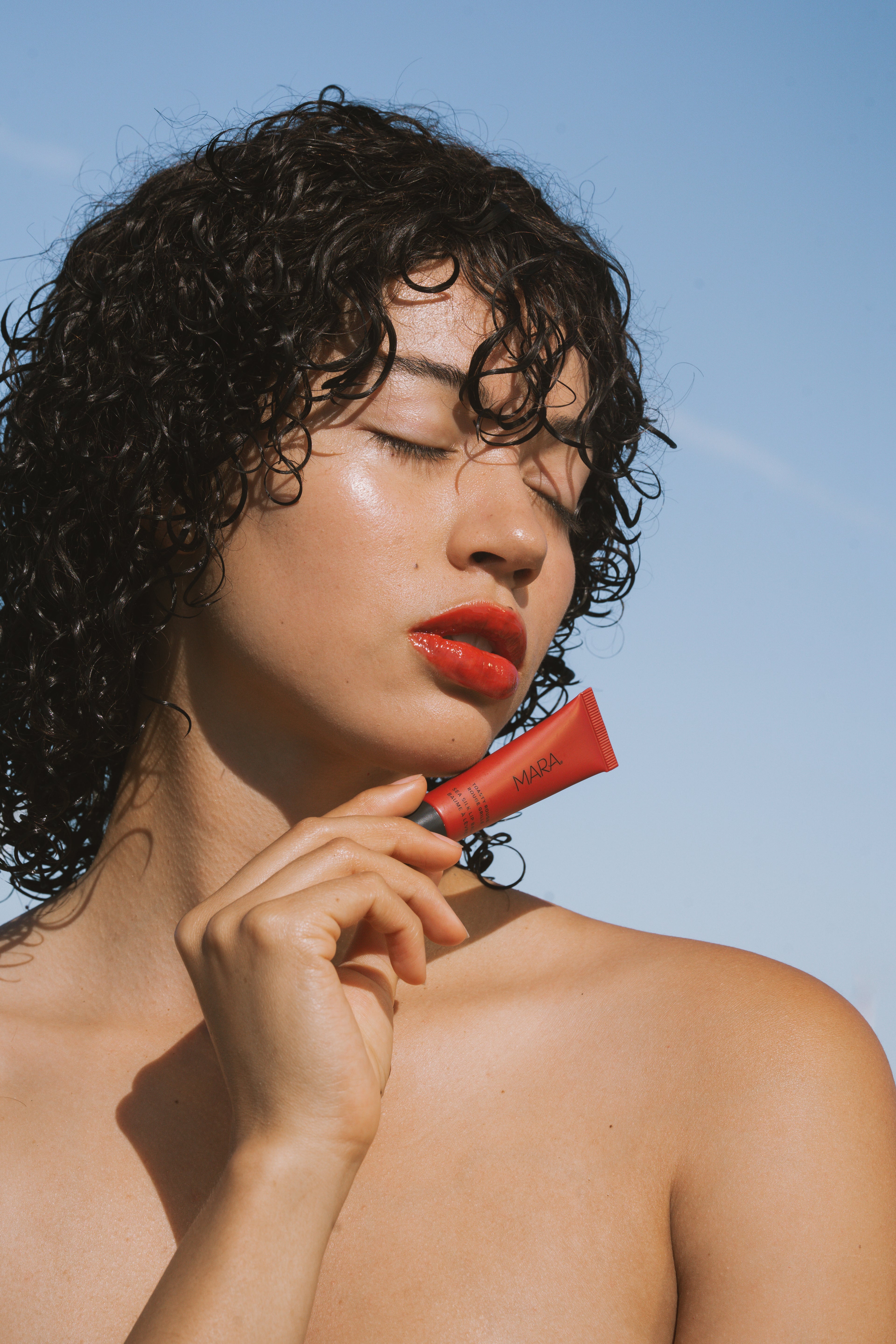 Model wearing Sea Silk Lip Balm in Toasty Rouge