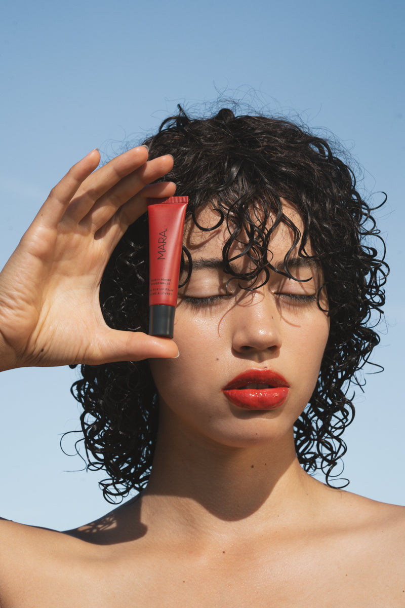 person holding Toasty Rouge Sea Silk Lip Balm