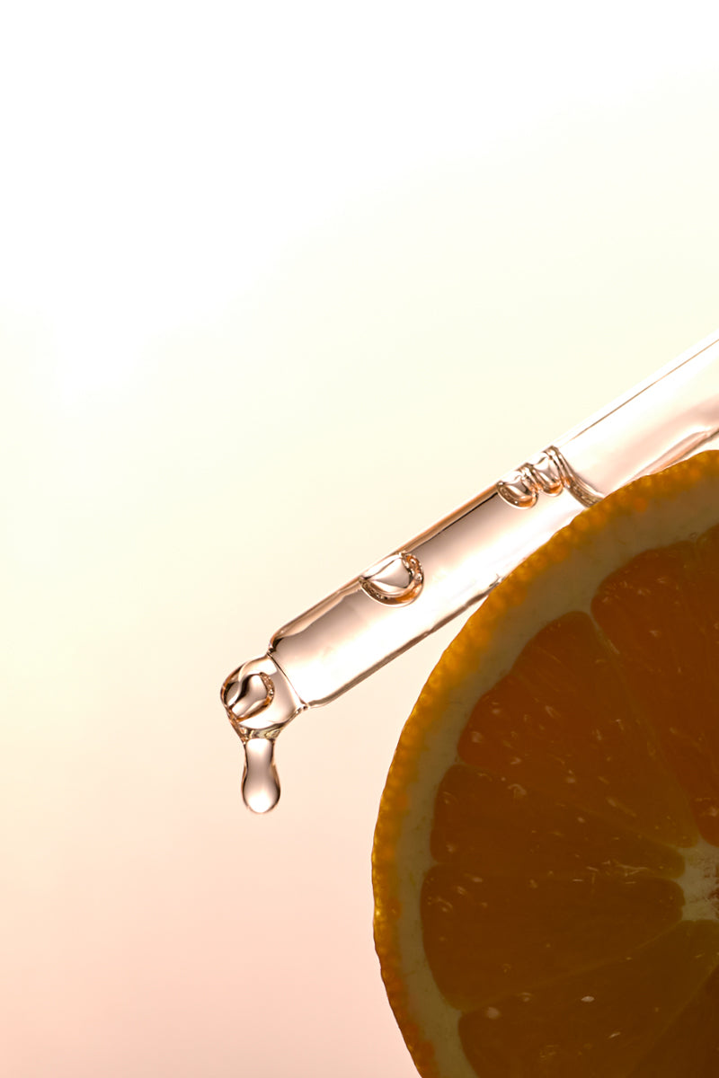 sea vitamin c serum dropper on top of an orange