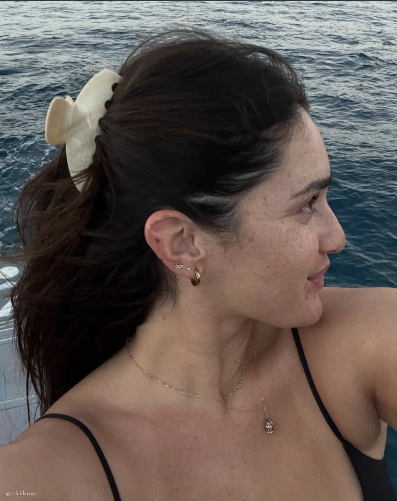 Model taking selfie in front of ocean
