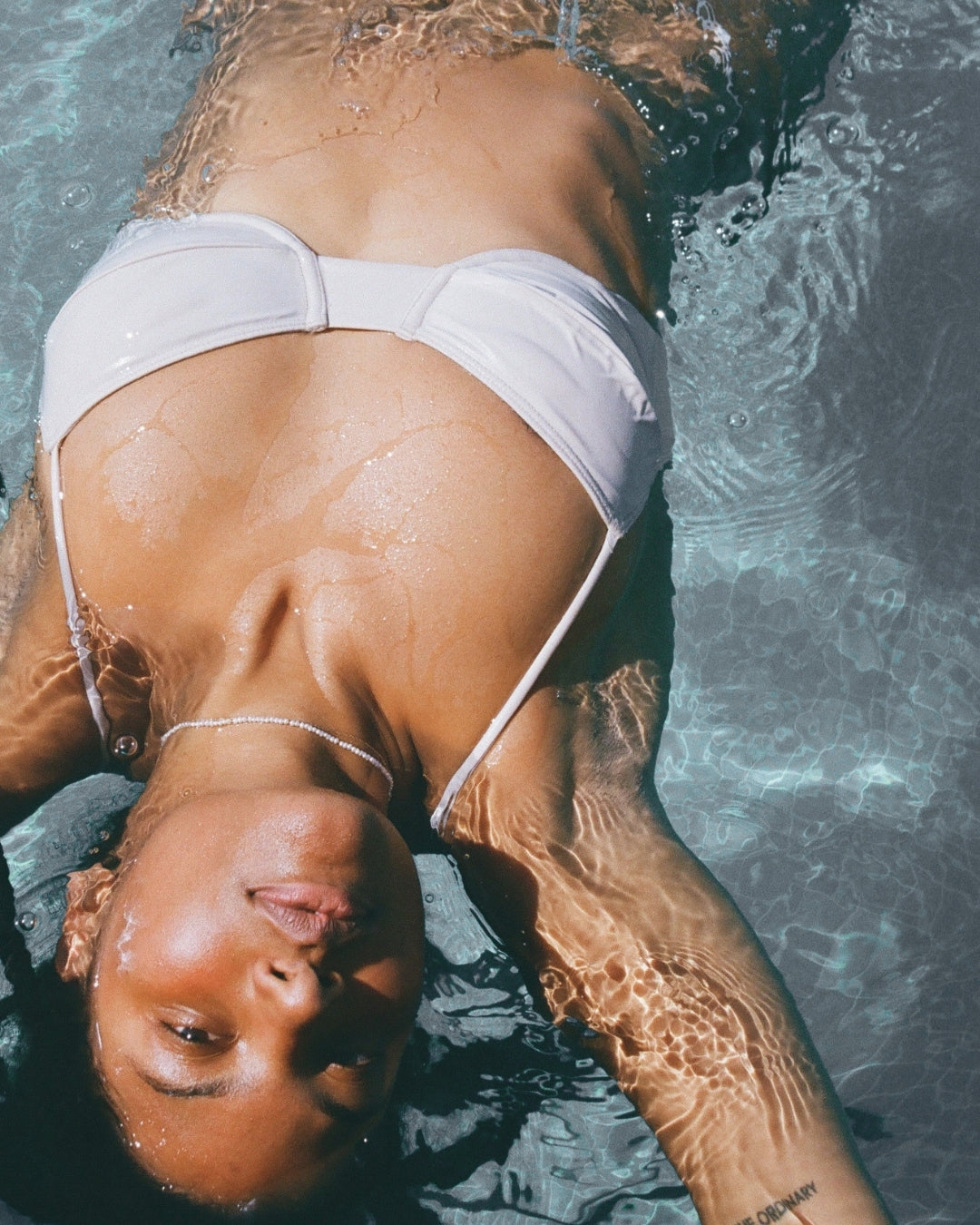 Tara Thomas floating in pool