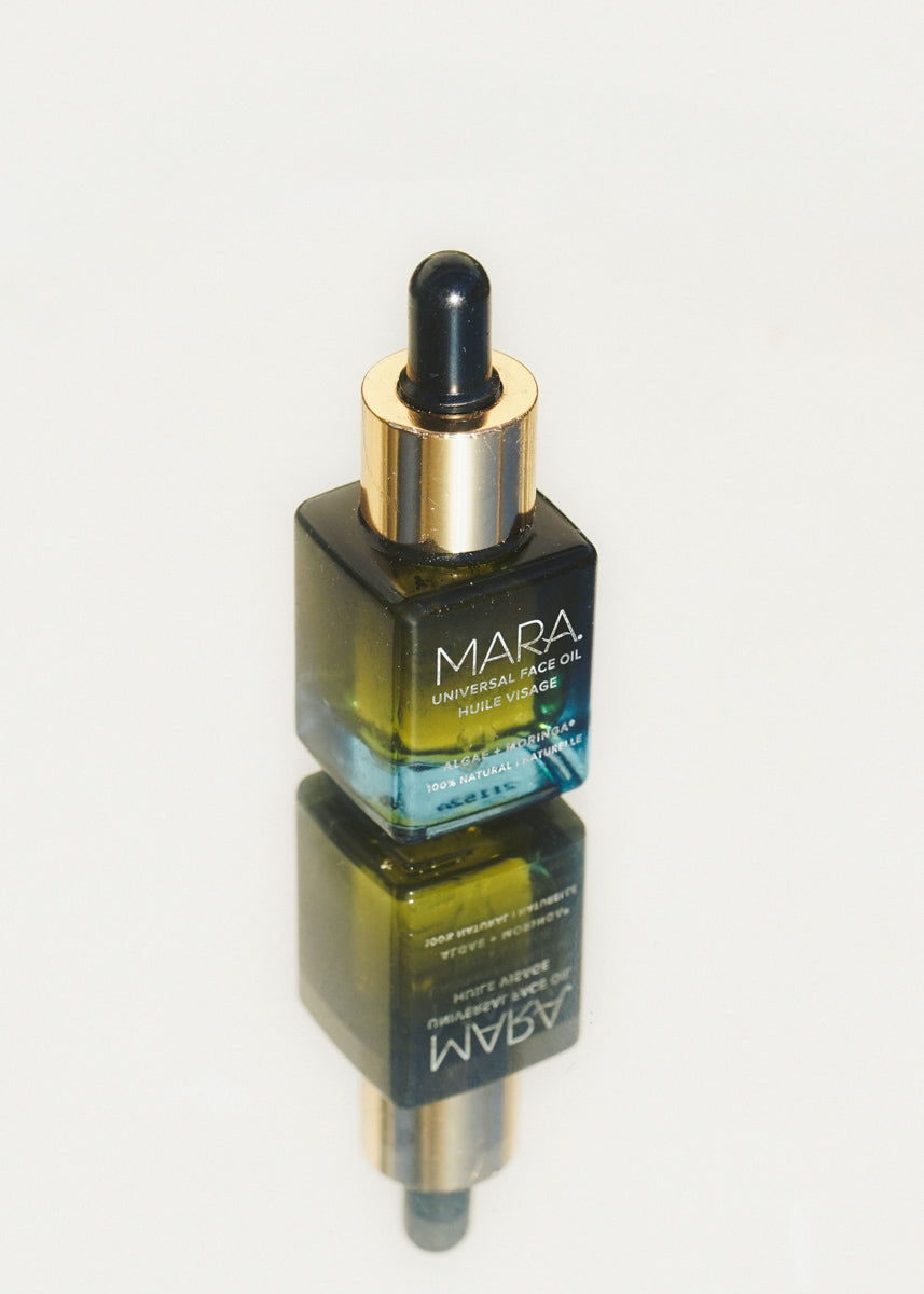 Universal Face Oil on a reflective light background