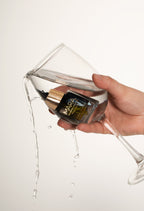 Mini Universal Face Oil in a glass of water