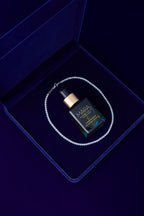 Universal Face Oil and diamond bracelet in a blue velvet jewelry box