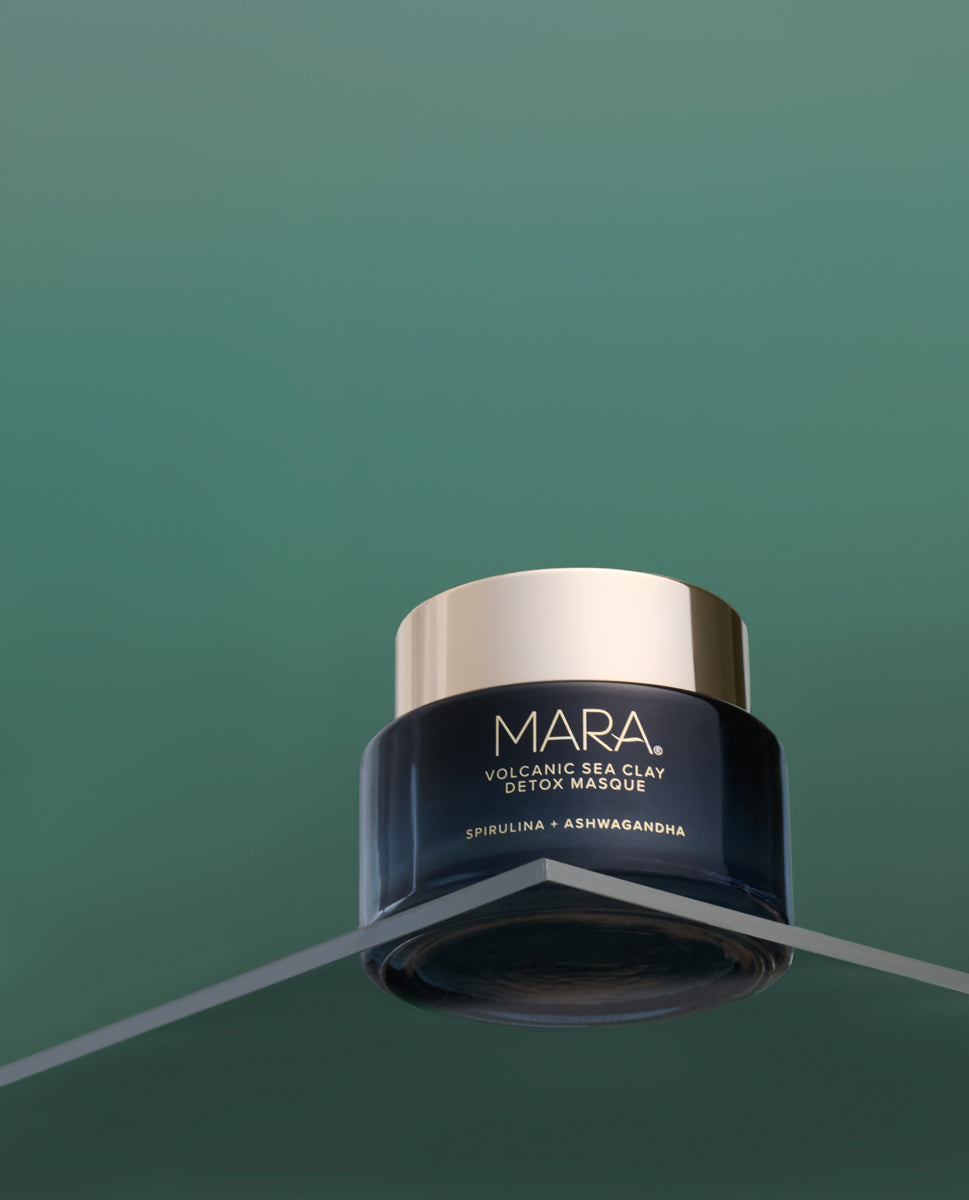 Volcanic Sea Clay Detox Masque on a clear shelf with a green background