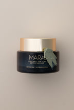 Volcanic Sea Clay Detox Masque with swatch on beige background