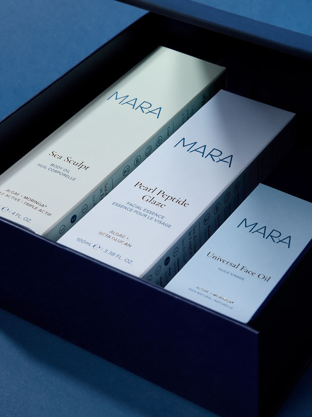 Sea Sculpt Body Oil, Pearl Peptide Glaze, Universal Face Oil in a Navy gift box