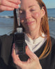 Allison applying Vitamin c serum at the beach 
