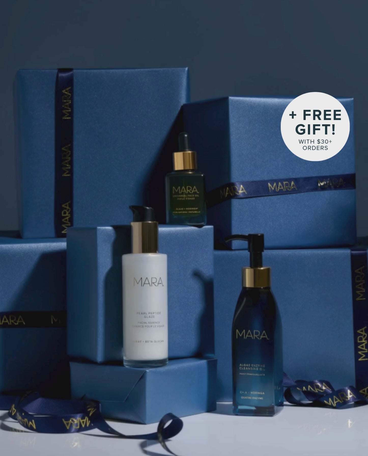 Cleansing Oil, Pearl Peptide, Universal on Navy gift boxes with ribbon unfurling