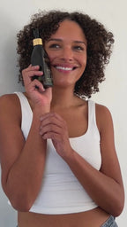 woman applying Sea Scult Body Oil to arm