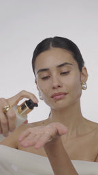 applying pearl peptide on her bare face