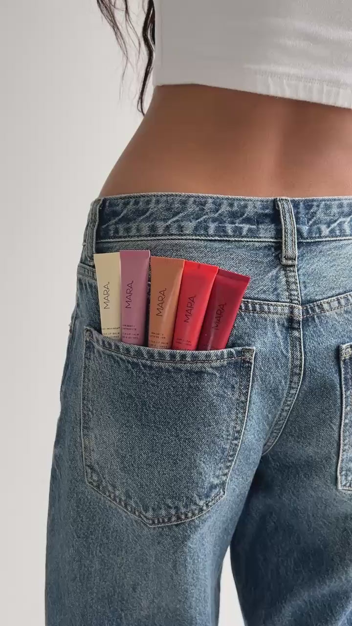MARA sea silk lip balm swatches in jean back pocket on model