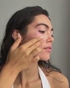 Woman applying Sea Dream Algae Creme to her cheek and rubbing it into her face 