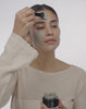 applying volcanic masque on bare face